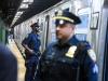 police man standing against a subway train